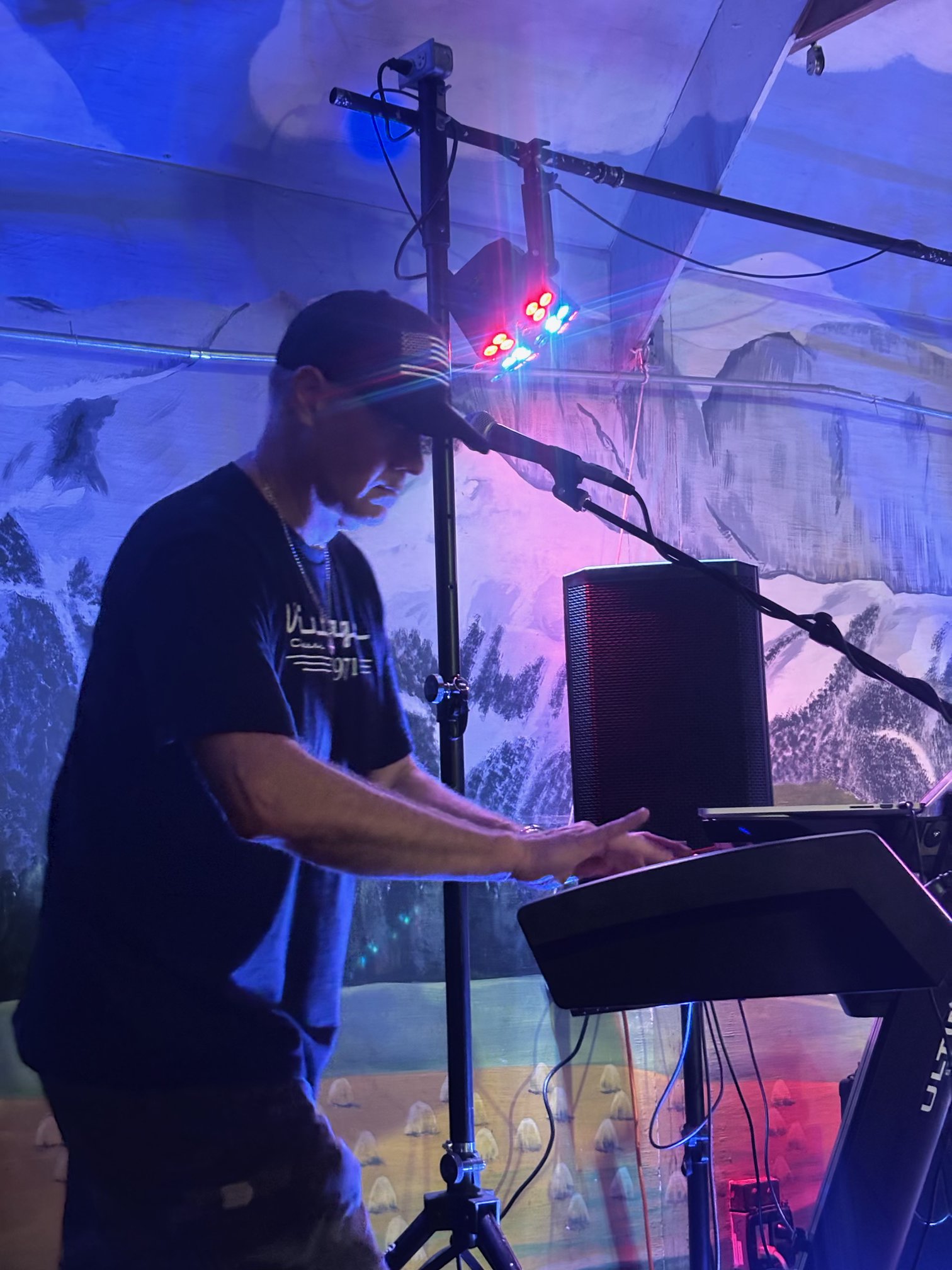 Matt Blauvelt playing keys under blue and red stage lights